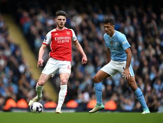 Declan Rice of Arsenal is challenged by Rodri of Manchester City during the Premier League match between Manchester City and Arsenal FC at Etihad Stadium on March 31, 2024 in Manchester, England. (Photo by Michael Regan/Getty Images) (Photo by Michael Regan/Getty Images)