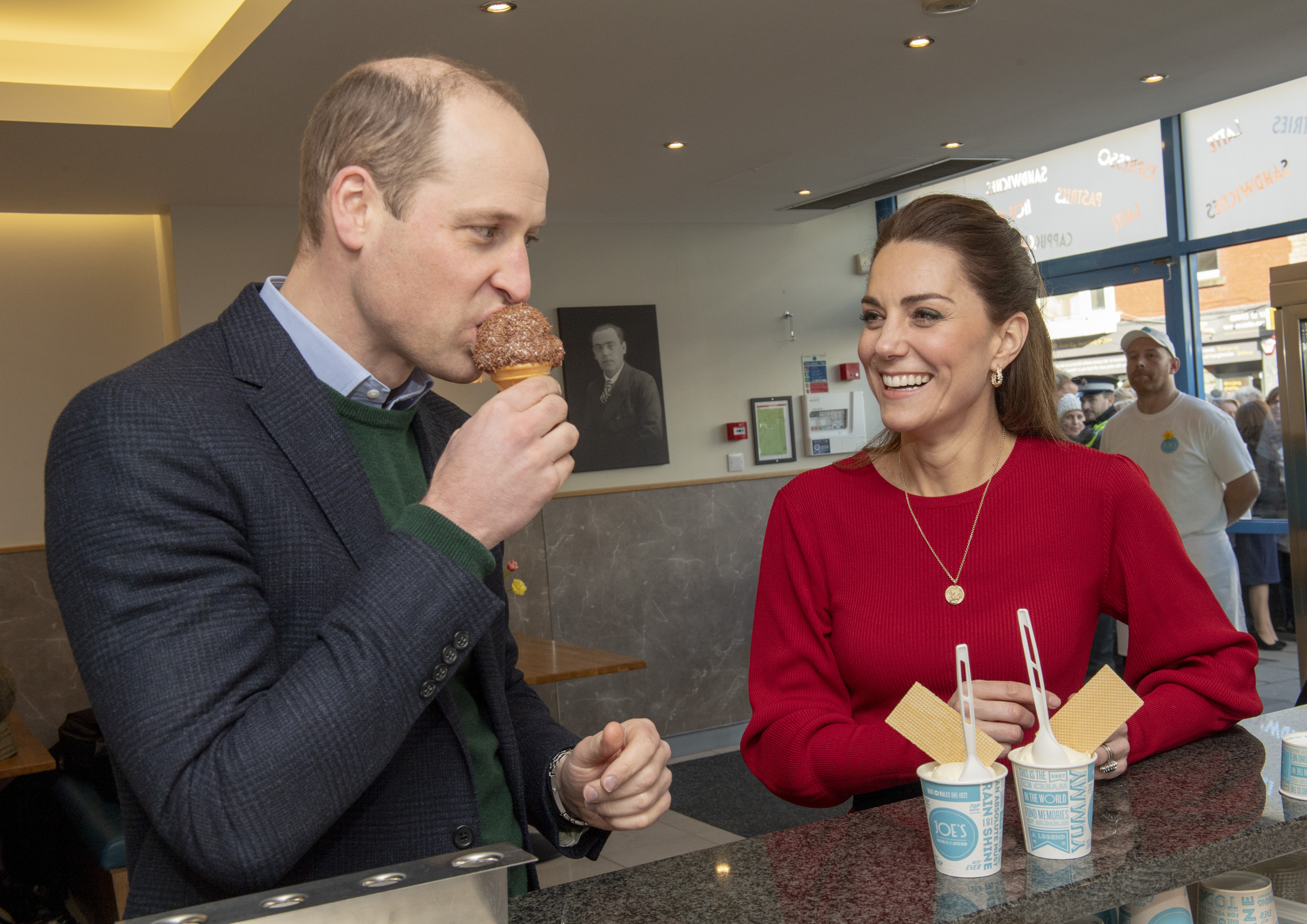 Prince William eating ice cream as Princess Kate smiles at him
