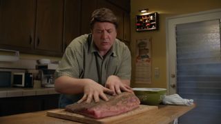George Sr. massaging the brisket on Young Sheldon