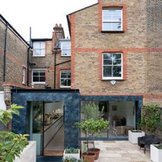 exterior of a brick house with modern extension and back patio