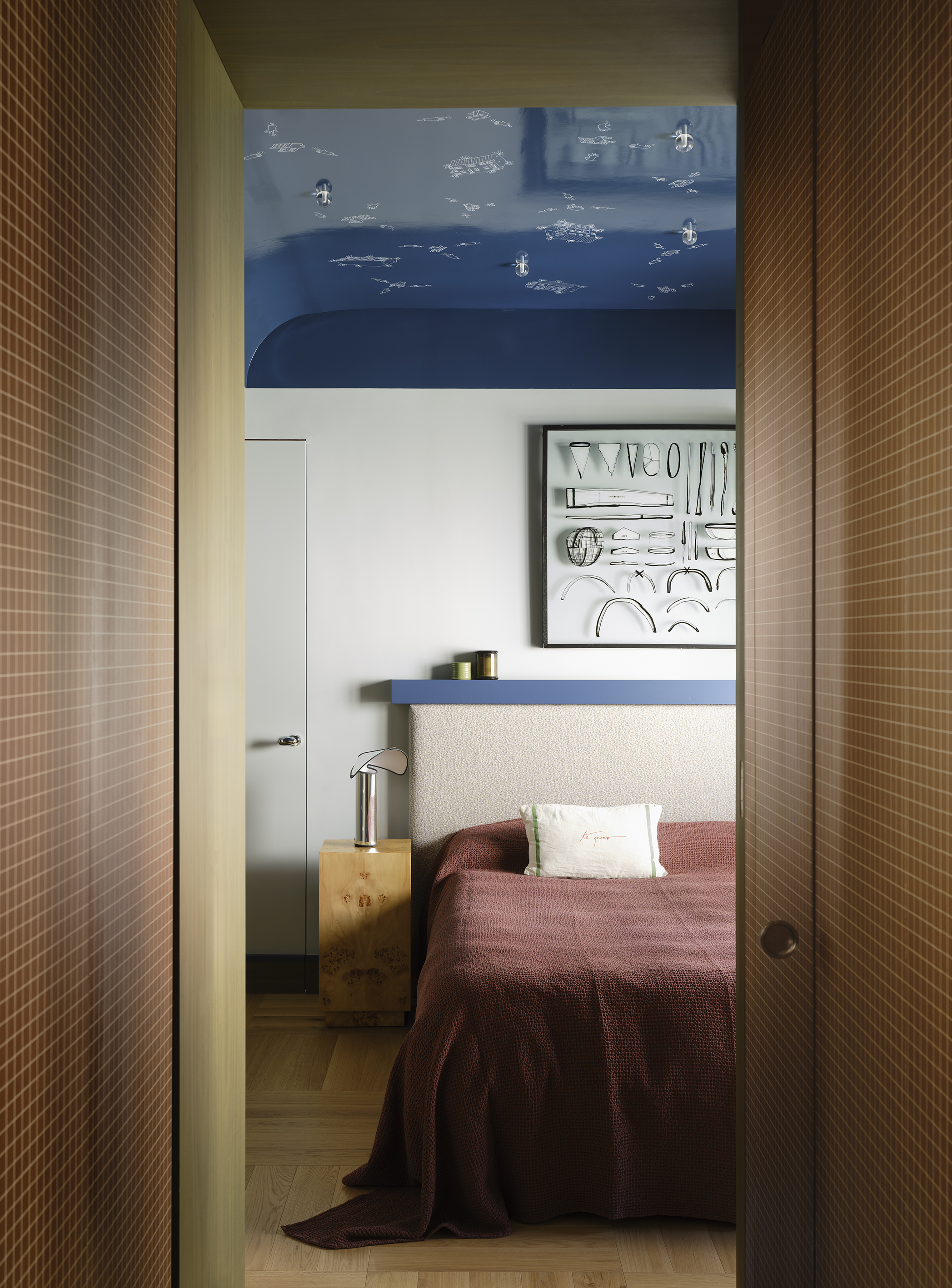 a neutral coloured bedroom design with a midnight blue vaulted ceiling and constellation design