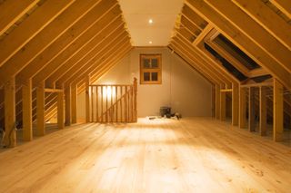 The inside of a loft being converted with wooden flooring