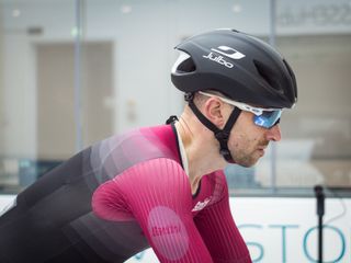 Tom riding in the wind tunnel wearing an aero helmet