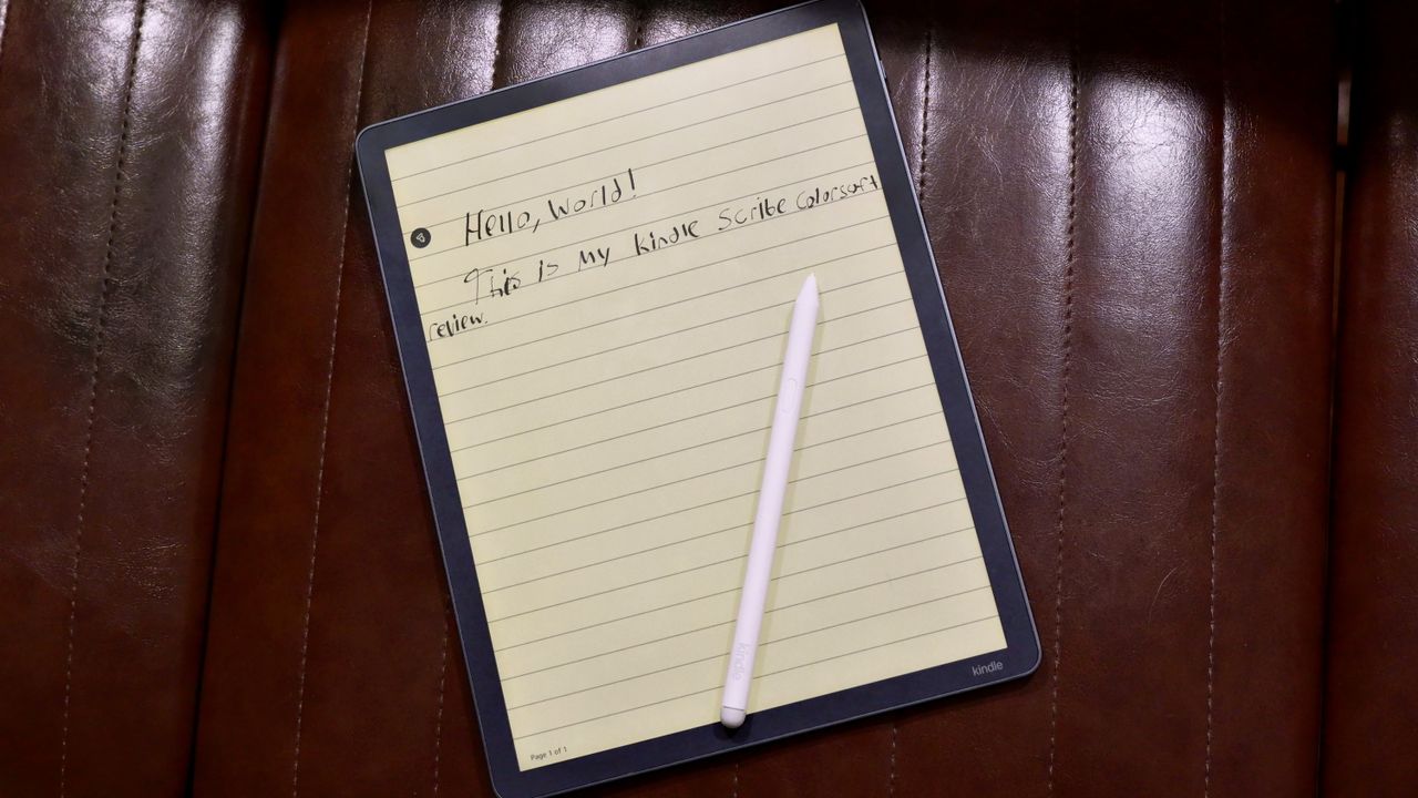 Amazon Kindle Scribe Colorsoft on a chair with a pen on top and the text reading, "Hello, world! This is my Kindle Scribe Colorsoft review."