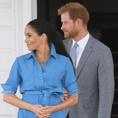 Prince Harry and Meghan Markle gaze away from the camera while in Australia