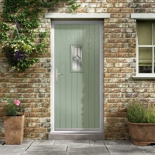 a green composite door with double glazing inset