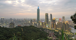 TAIPEI, NEW TAIPEI CITY, TAIWAN - 2024/02/10: An elevated view of Taipei city during twilight with skyscrapers against a subtle sunset, taken from a mountainous area with foliage. (Photo by Jorge Fernández/LightRocket via Getty Images)
