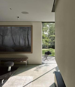Winter House featuring view through living spaces and looking towards the green garden