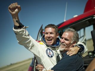 Skydiver Felix Baumgartner of Austria and Technical Project Director Art Thompson of the Unites States celebrate after successfully completing the world's highest skydive, a supersonic leap, for Red Bull Stratos in Roswell, New Mexico, on Oct. 14, 2012.