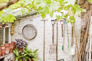 shed storage ideas: hanging tools on white wall