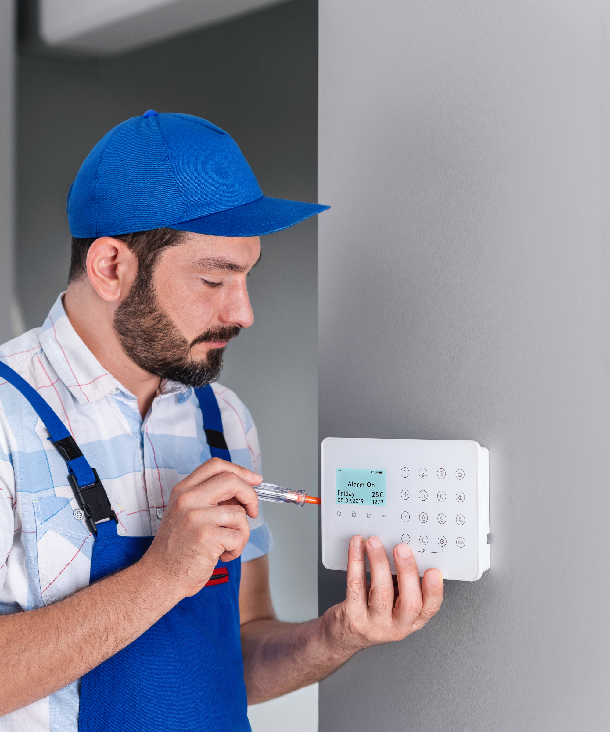 technician wiring in home alarm system