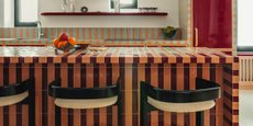 striped tile kitchen island with peachy orange and maroon tiles