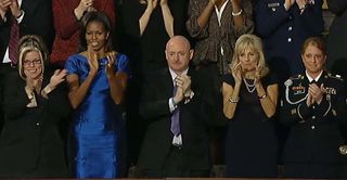 Former NASA astronaut Mark Kelly applauds President Barack Obama after the 2012 State of the Union address on Jan. 24, 2012.