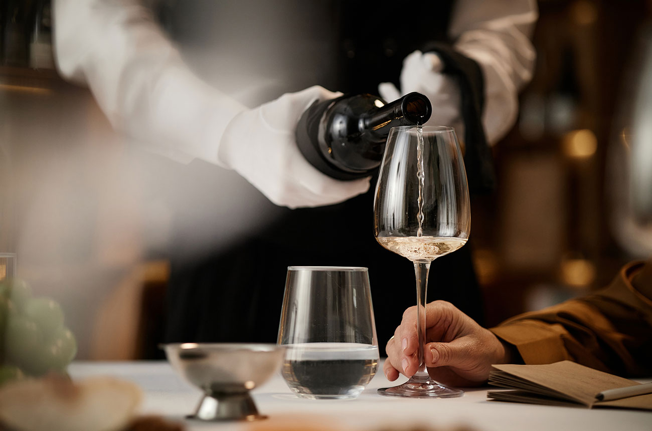 sommelier serving wine