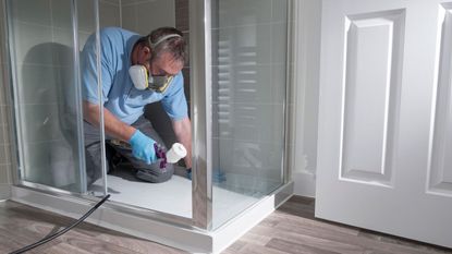 man fixing shower with diy skills by plastic surgeon