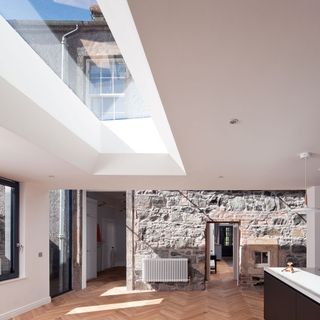 traditional victorian house with glass ceiling and stone wall