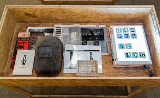 vitrines are filled with flyers, magazines, photos, drawings and other ephemera