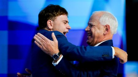 Minnesota Gov. Tim Walz embraces his son at the Democratic National Convention in Chicago.