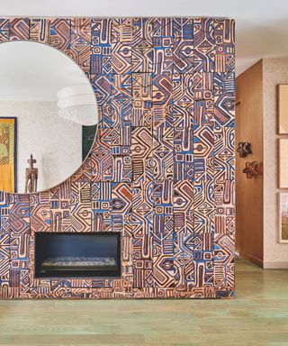 abstract patterned wall of colourful tiles surrounding a fireplace