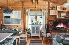 An open-plan living and dining space set in a fully-panelled log cabin