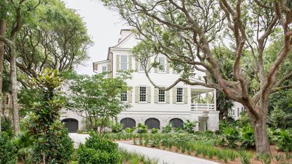 exterior of white painted clapboard house with veranda 