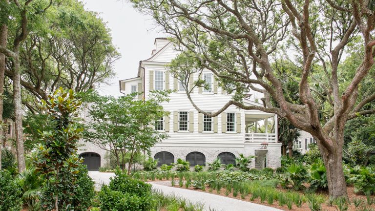 exterior of white painted clapboard house with veranda