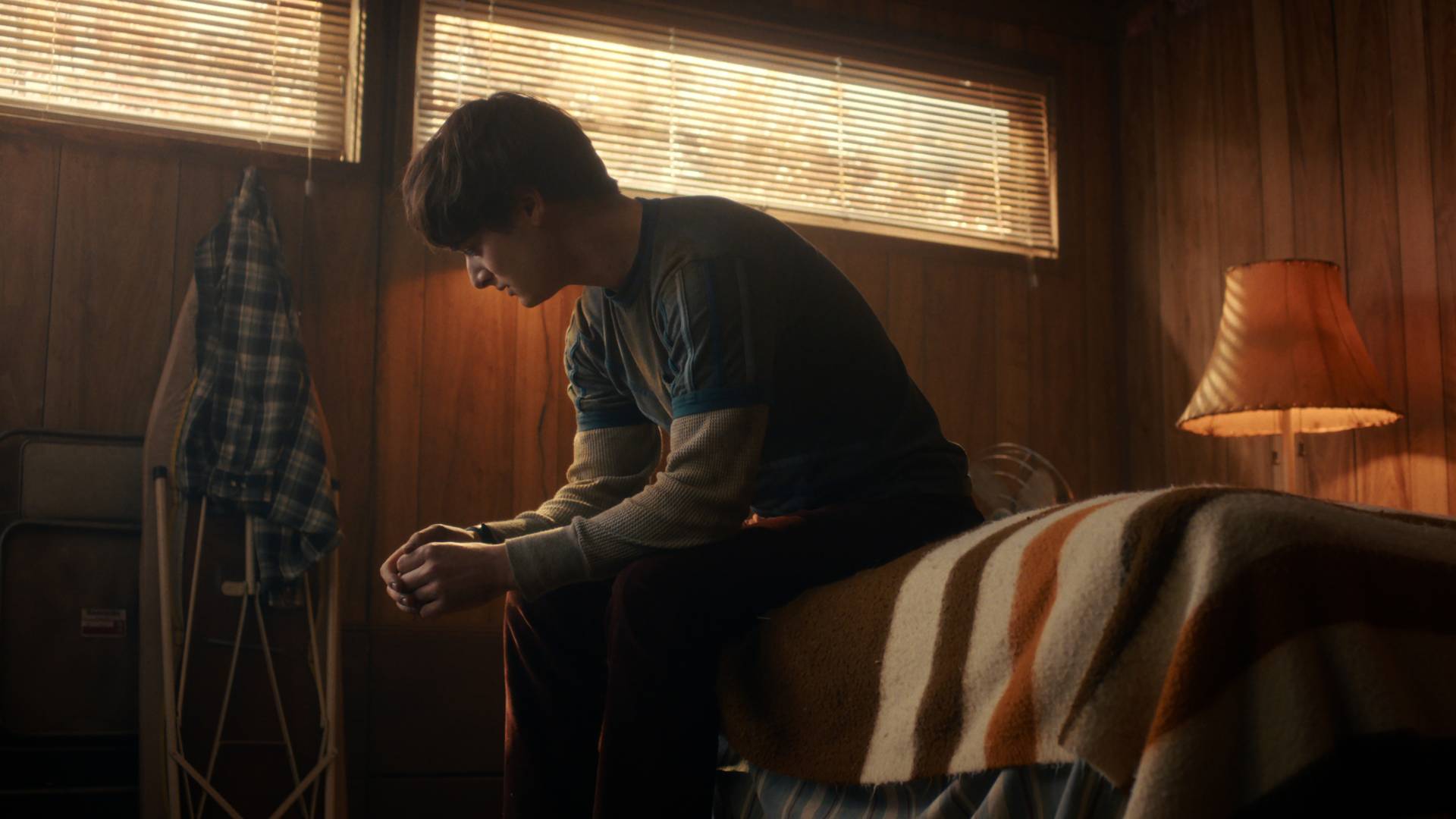 Noah Schnapp as Will Byers in Stranger Things Season 5 volume 2, sitting on a bed