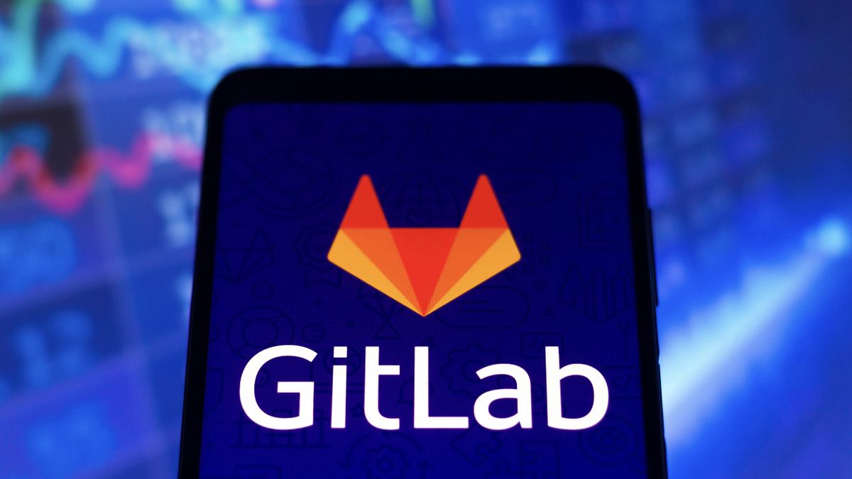 The GitLab logo on a smartphone in front of a background of data