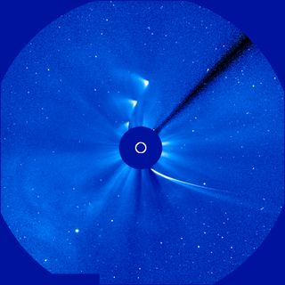 This time-lapse image shows Comet ISON approaching and leaving during its slingshot around the sun – represented by the white circle -- on Nov. 28, 2013. The ISON images clearly outline the curve of the comet's orbit path. The images were captured by ESA/