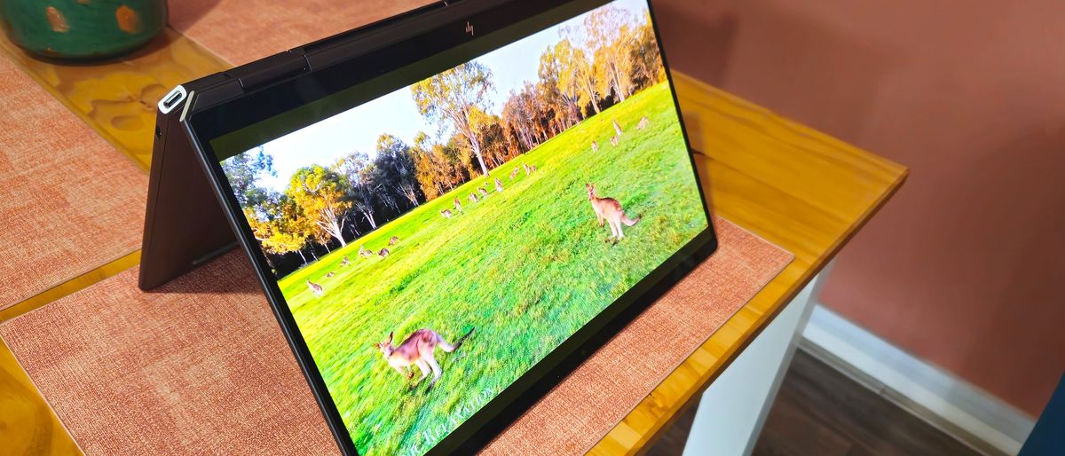 HP Spectre x360 14 (2024) in &#039;flip&#039; configuration on a wooden table