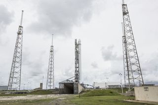 An unmanned Dragon spacecraft and its Falcon 9 rocket stand ready to launch toward the International Space Station to deliver NASA cargo on Sept. 20, 2014.