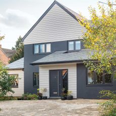 house exterior with grey wall and slate tile flooring