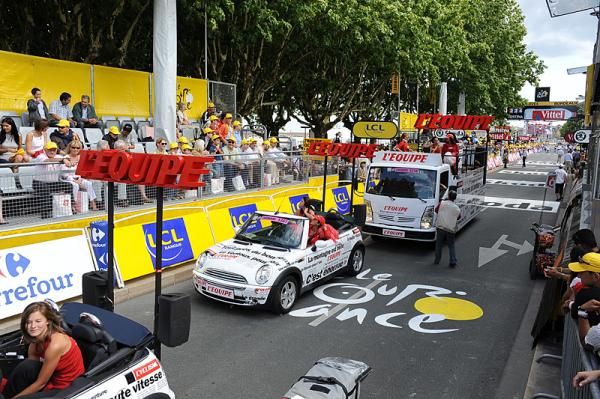 The L'Equipe cars come through in the caravan at the Tour de France