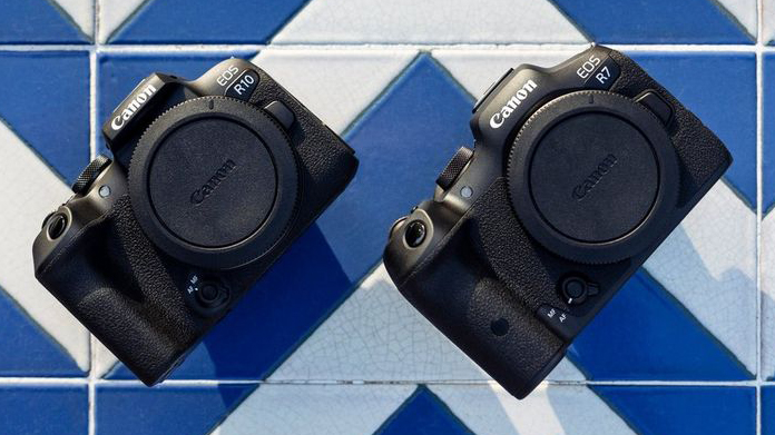 The Canon EOS R7 camera next to the EOS R10