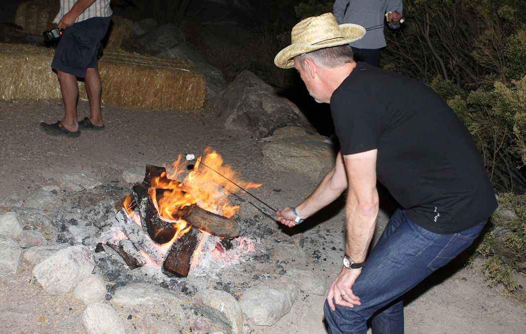 Polcartec CEO Gary Smith roasts a marshmallow in the Coyote Corral