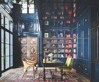 library with blue cabinetry and persian rug