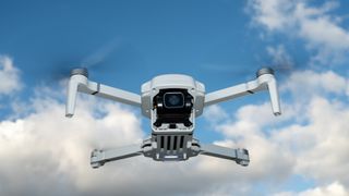 Holy Stone HS360E in flight against a blue sky