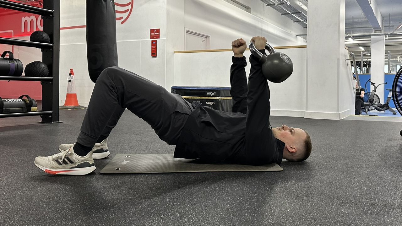 Ollie Thompson performing a kettlebell floor press