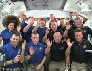 The 12 astroanuts of the International Space Station and shuttle Endeavour wave to Pope Benedict XVI after a papal call from The Vatican on May 21, 2011 (Flight Day 6) during NASA's STS-134 mission.