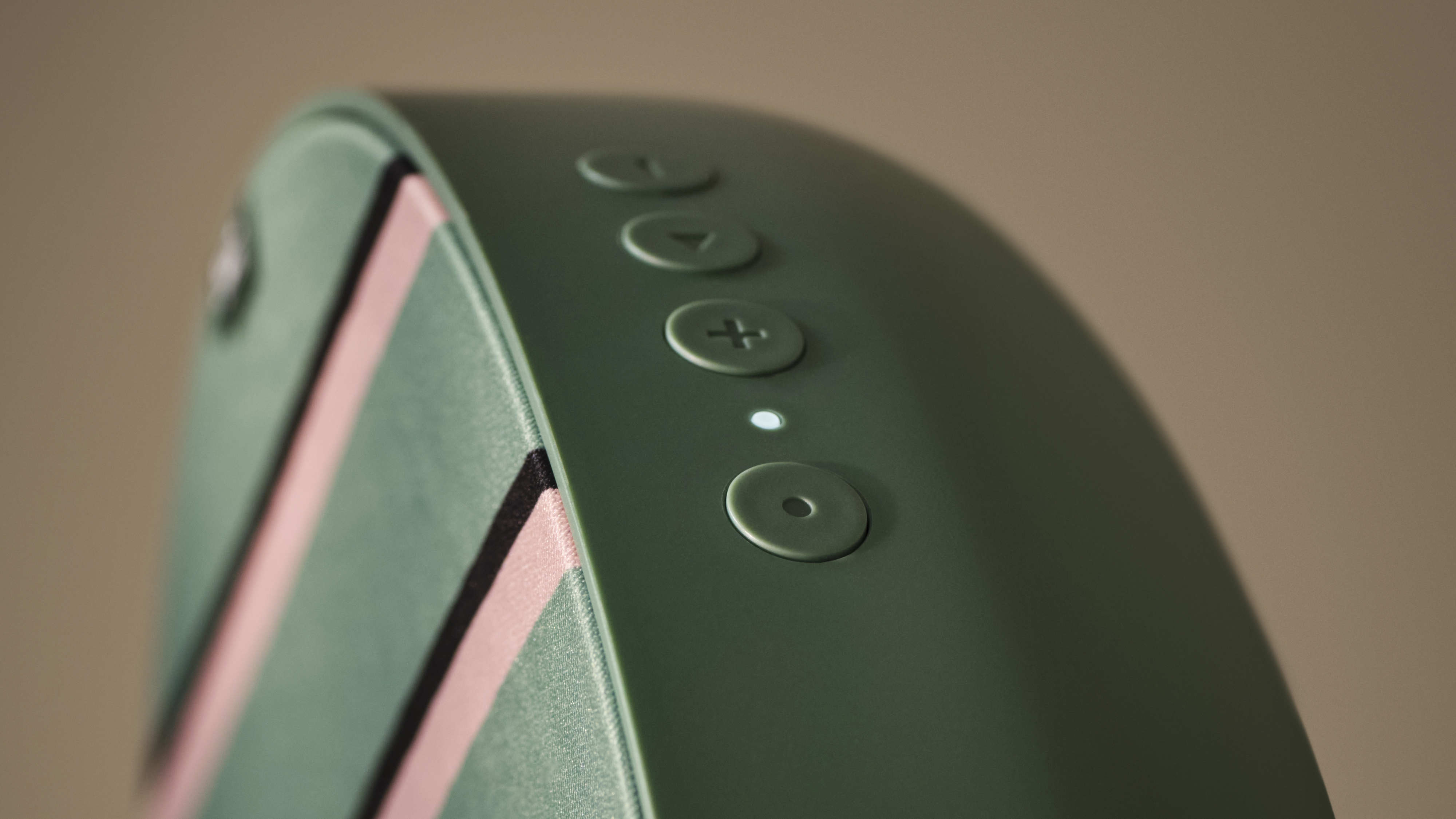 An IKEA SOLSKYDD Bluetooth speaker on a brown background