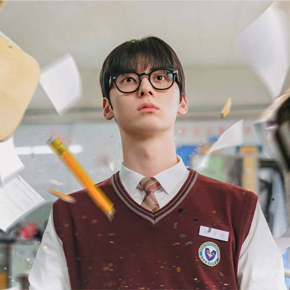 Korean high school student Yoon Ga-min (Hwang Min-hyun) sits in a classroom, with papers and pencils flying around him, in the K-drama 'Study Group.'