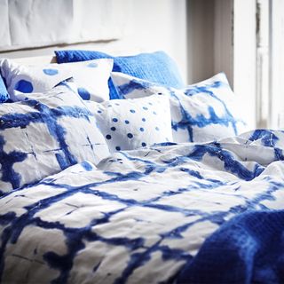 ikea collection of blue with white bedsheet and polka dotted pillows