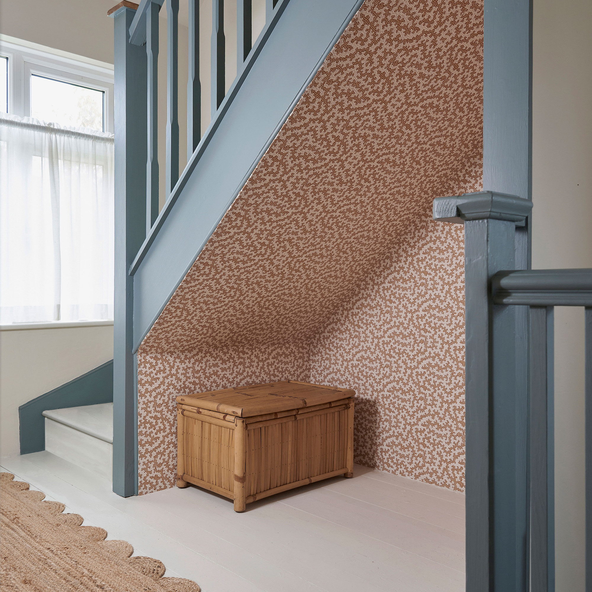 staircase with wallpaper in the alcove