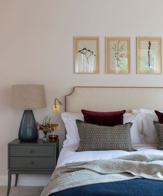 a neutral bedroom by Kitesgrove with a bedside lamp and a small wall reading light