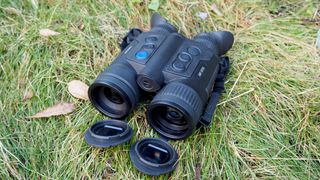 Pulsar Merger LRF XP35 binoculars on a grassy surface