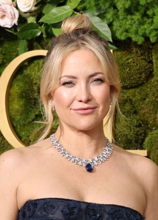 Actress Kate Hudson looks radiant in a black strapless gown and diamond necklace