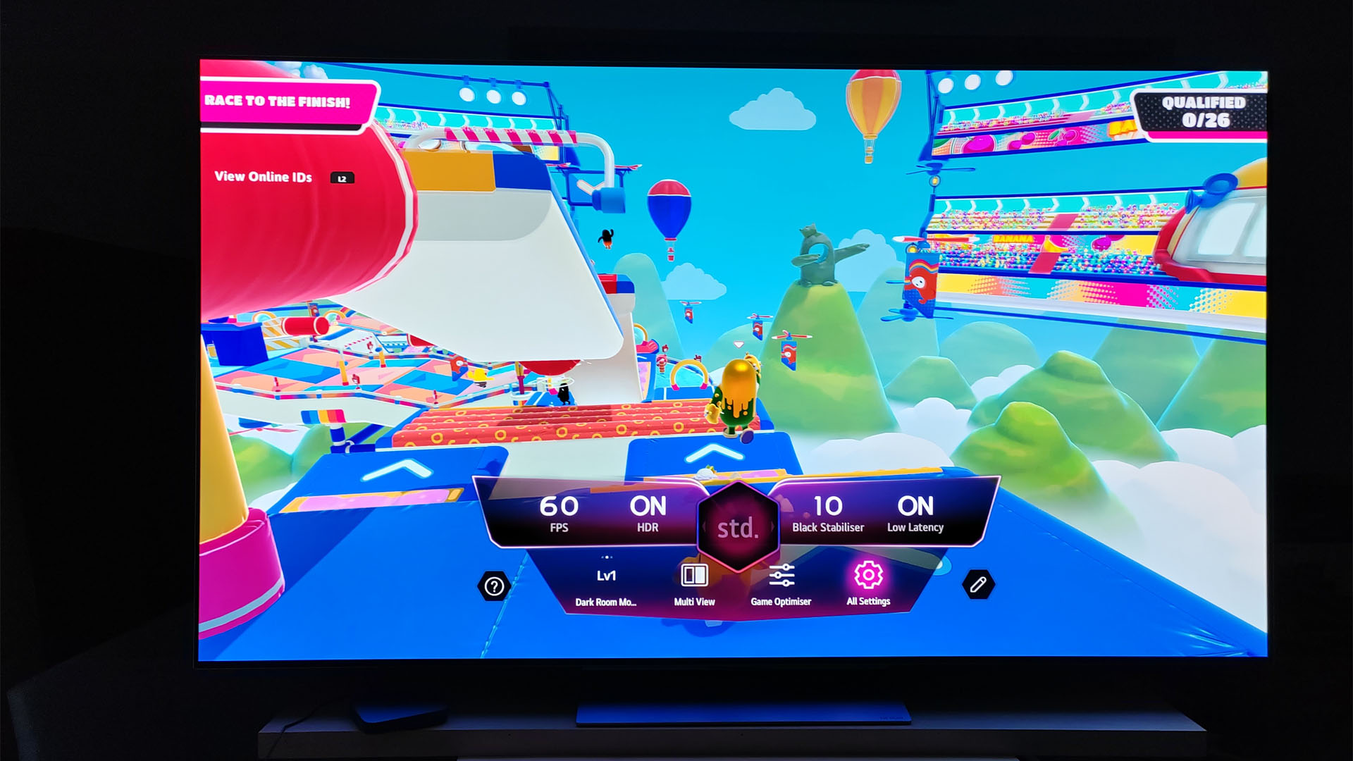 LG OLED G3's in-game UI showing a summary of its gamer features and settings - displayed over a game of fall guys