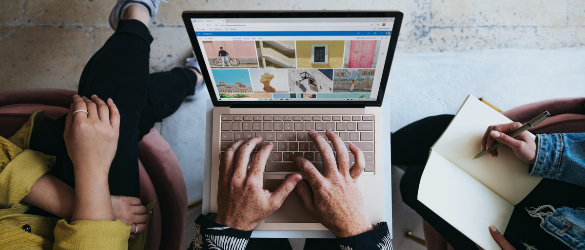 Three designers sitting around a laptop