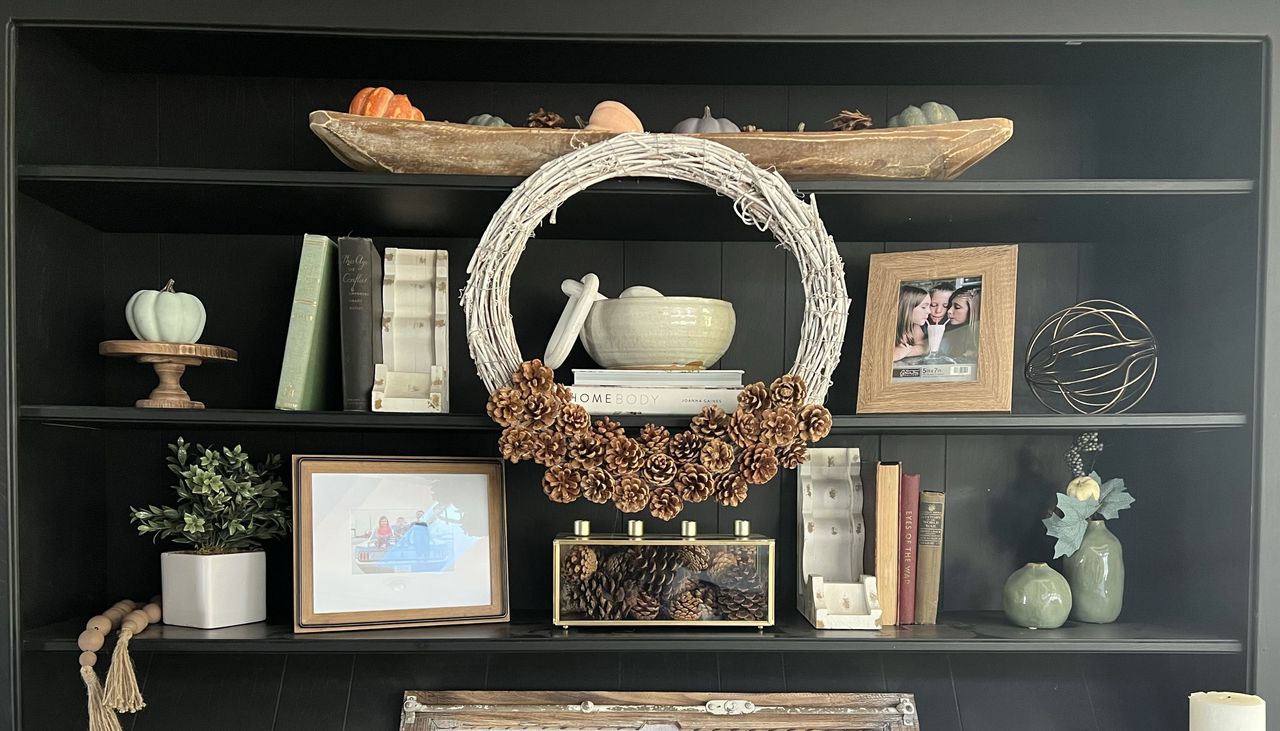 pinecone wreath on bookshelf