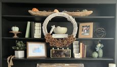 pinecone wreath on bookshelf